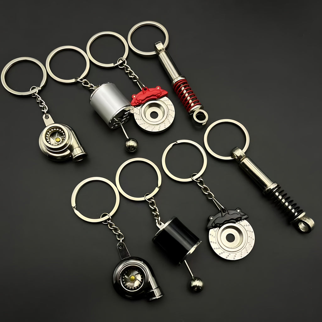 4-Piece Car Lover Keychain Set 🚗🗝️ – Zinc Alloy with Turbo, Gear, and Shock Absorber Designs